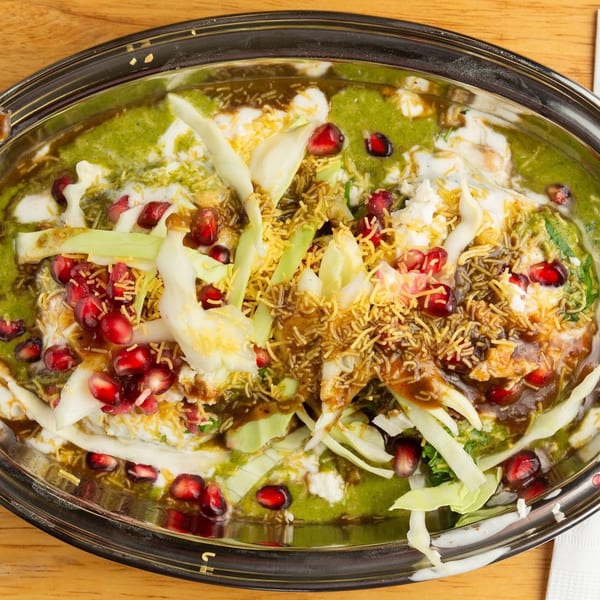 Chit Chaat Cafe's Indian chaat dish, garnished with pomegranate seeds, cabbage, and sev.